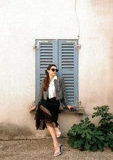 A lady wears a black tulle skirt.